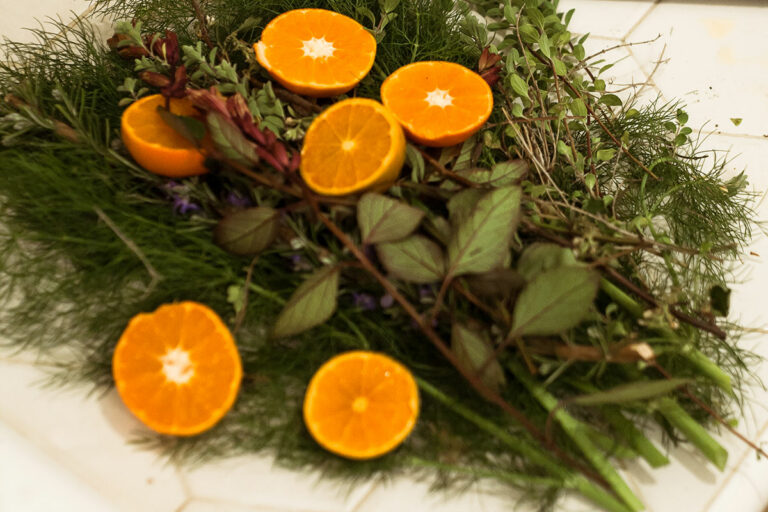 Herbs in a pile with citrus.