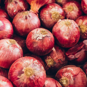 Red onions in pile