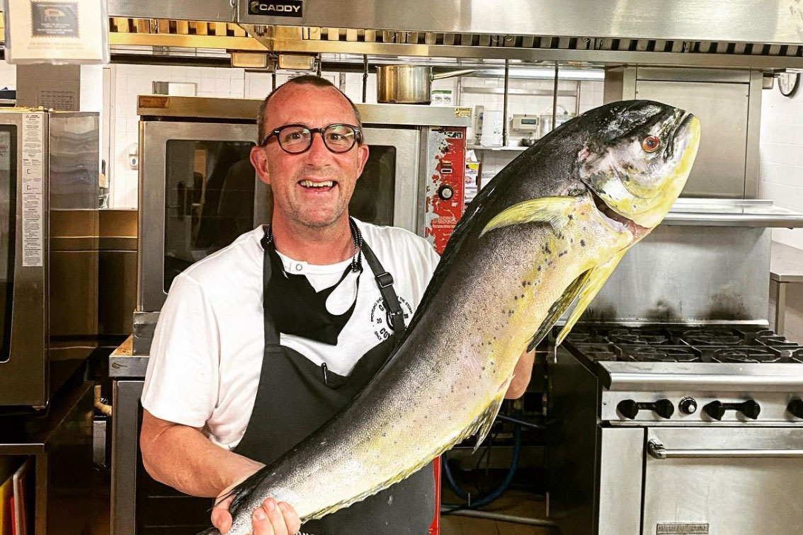 Chef Jason McLeod holding a large fish.